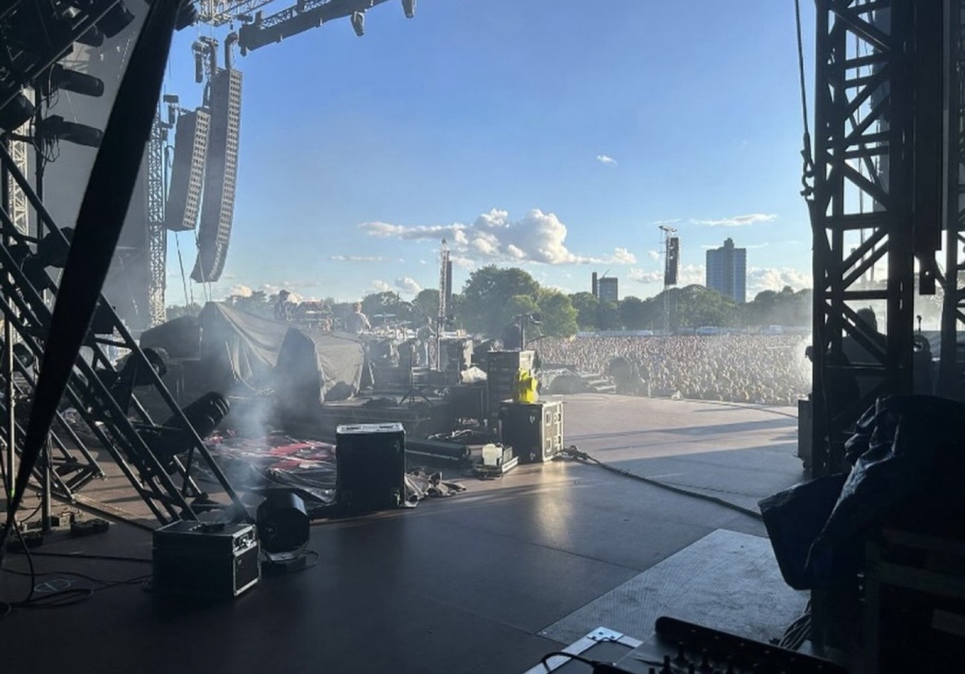 View from the stage at Kasabian's Summer Solstice II in Victoria Park, Leicester, looking out over the crowd and skyline.